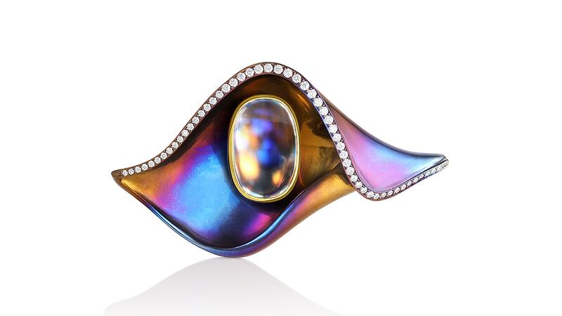 An “Ojo” brooch with a rainbow moonstone as the eye accented by diamonds in multi-color titanium Adam Neeley Dalí’s Garden Ojo Brooch